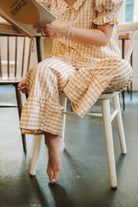 Patron de couture Maéli Paris pour pantalon à volants Pauline, version vichy, style décontracté.